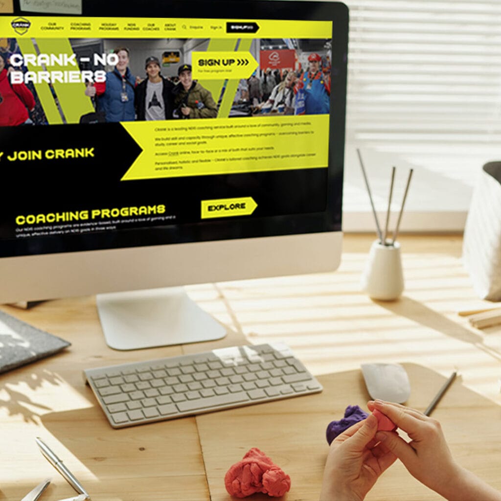 A woman is sitting at a desk with a computer.
